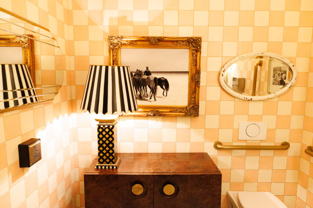 The pink and white checkerboard tiles on the wall of the cute bathroom at Mandy's Gourmet Salads in Yorkville, Toronto.