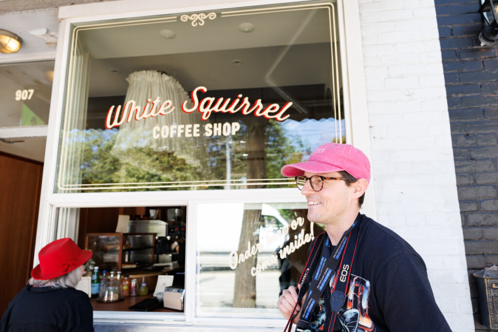 Toronto Star staff-photographer, and photojournalist Nick Lachance standing in front of White Squirrel coffee shop on Queen Street West in Toronto.
