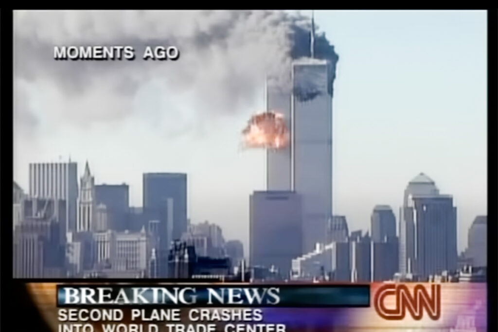 A screenshot of live CNN tv coverage of 9/11. A plane has just struck the South Tower of the World Trade Center.