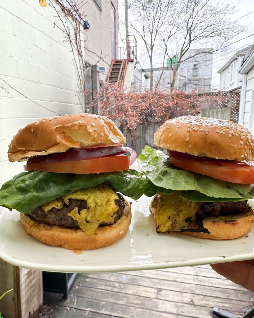 A hamburger with grilled pineapple, made by Chino for lunch at Crows Nest Barbershop in Kensington Market in Toronto.