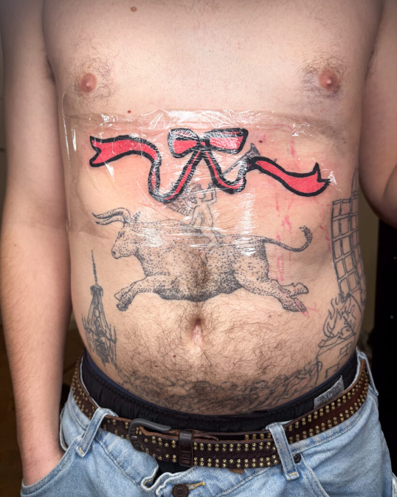 A tattoo of a coquette pink ribbon by Douglas Tynes, aka Brotel6.