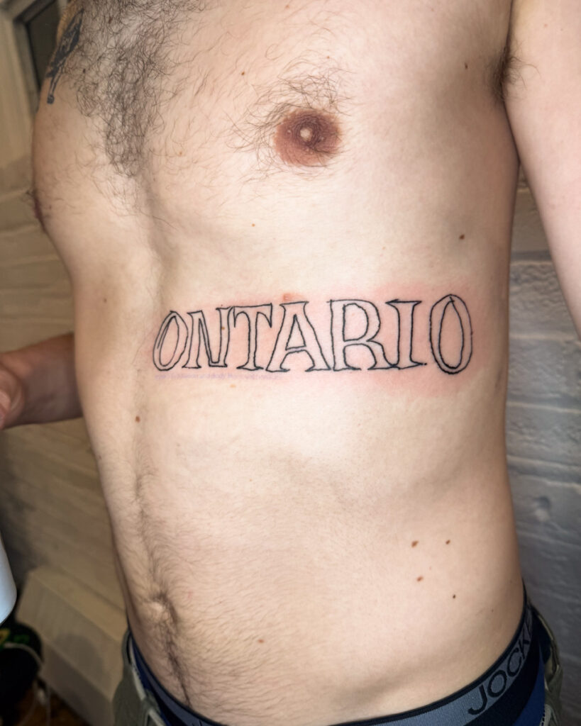 A tattoo of the word 'Ontario' by Douglas Tynes, aka Brotel6.
