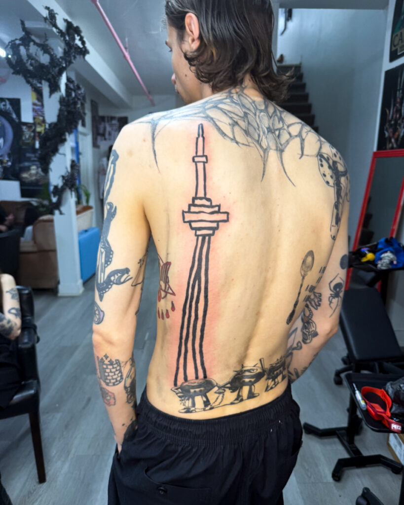 A back tattoo of the CN Tower by Douglas Tynes, aka Brotel6.