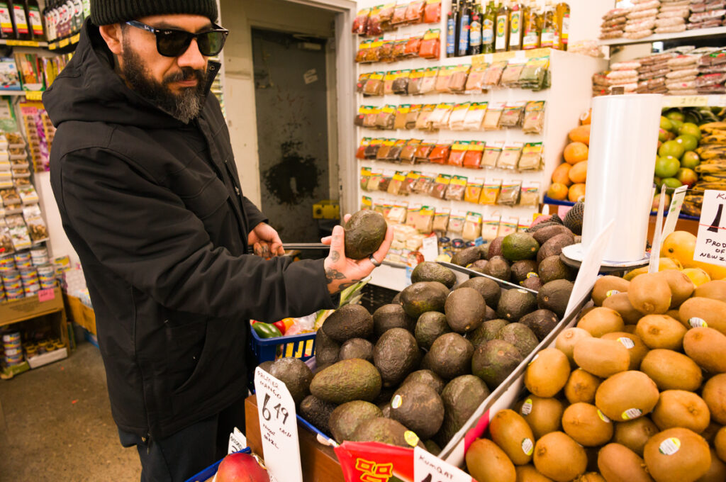 Chino is buying an avocado in Kensington Market, Toronto.