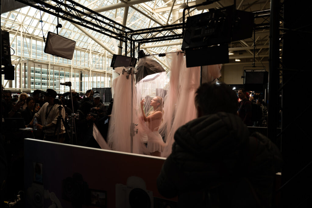A model poses for photographs at the Sony booth at ProFusion Expo 2025 in Toronto.