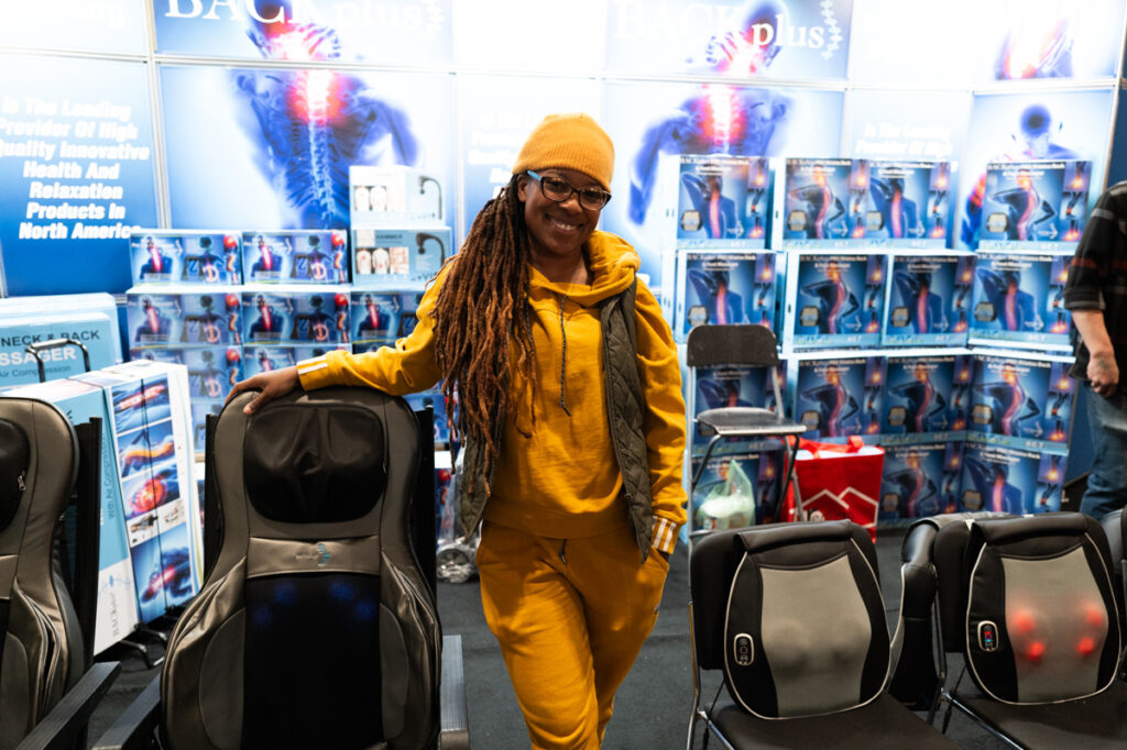 A salesperson at a booth selling electric back massagers at The Royal Agricultural Winter Fair in Toronto.