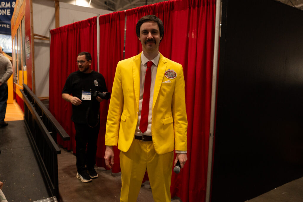 The host of the Gay Lea butter sculpting contest for kids in his butter-yellow suit at The Royal Agricultural Winter Fair in Toronto.